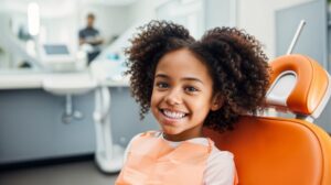 Happy, smiling young girl in dental treatment chair